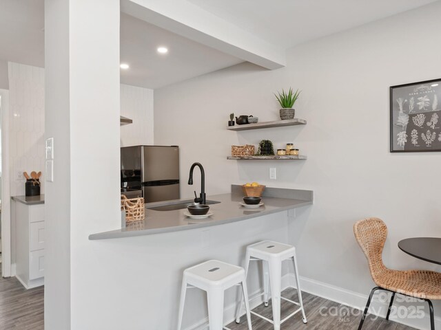 2000 Patio Ct Unit 101, 105, 125, Charlotte, NC 28205 - kitchen with freestanding refrigerator, wood finished floors, a kitchen bar, recessed lighting, and light countertops