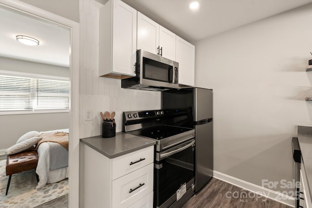 2000 Patio Ct Unit 101, 105, 125, Charlotte, NC 28205 - kitchen featuring stainless steel appliances, dark wood-type flooring, white cabinets, and dark countertops
