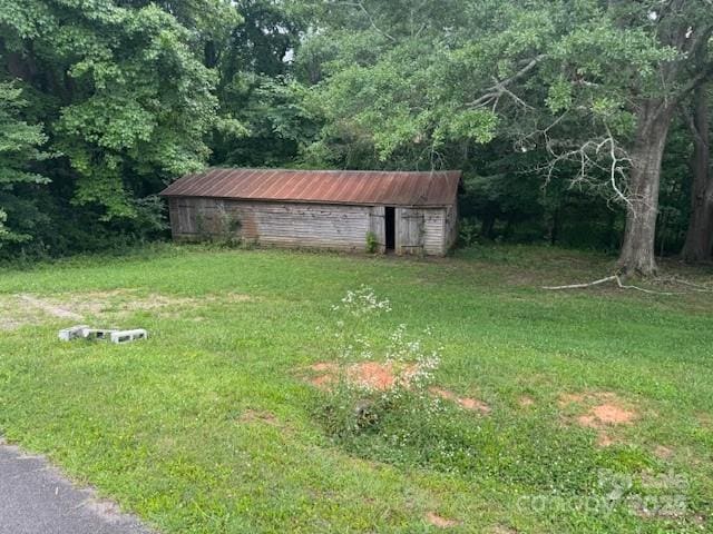2116 Dana Pl, Shelby, NC 28152 - view of grassy yard with an outdoor structure and a wooded view
