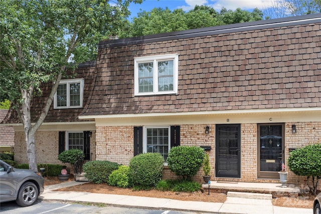 3500 Colony Rd Unit B, Charlotte, NC 28211 - view of property with brick siding, mansard roof, and uncovered parking