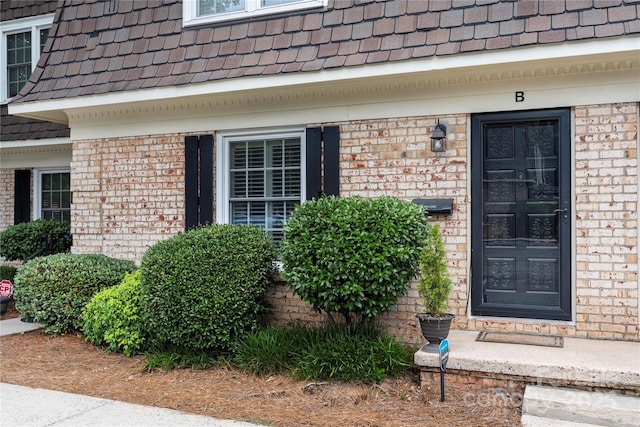 3500 Colony Rd Unit B, Charlotte, NC 28211 - view of exterior entry with a shingled roof, brick siding, and mansard roof