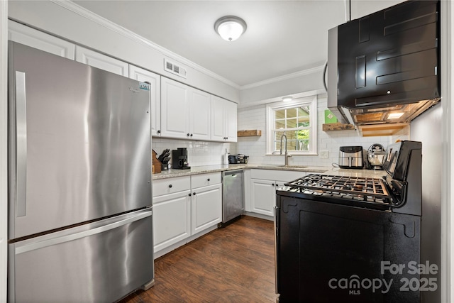 3500 Colony Rd Unit B, Charlotte, NC 28211 - kitchen featuring appliances with stainless steel finishes, ornamental molding, white cabinetry, backsplash, and dark wood-type flooring