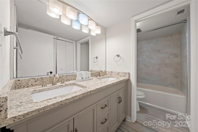 3500 Colony Rd Unit B, Charlotte, NC 28211 - bathroom featuring double vanity, wood finished floors, and washtub / shower combination