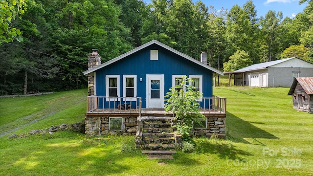 2428 Hamburg Rd, Mars Hill, NC 28754 - back of house with a chimney, a lawn, and a deck