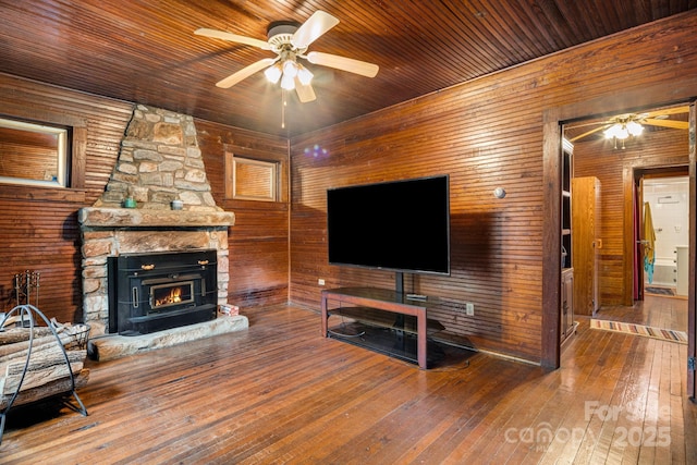 2428 Hamburg Rd, Mars Hill, NC 28754 - living room featuring ceiling fan, wood walls, hardwood / wood-style floors, a large fireplace, and wooden ceiling