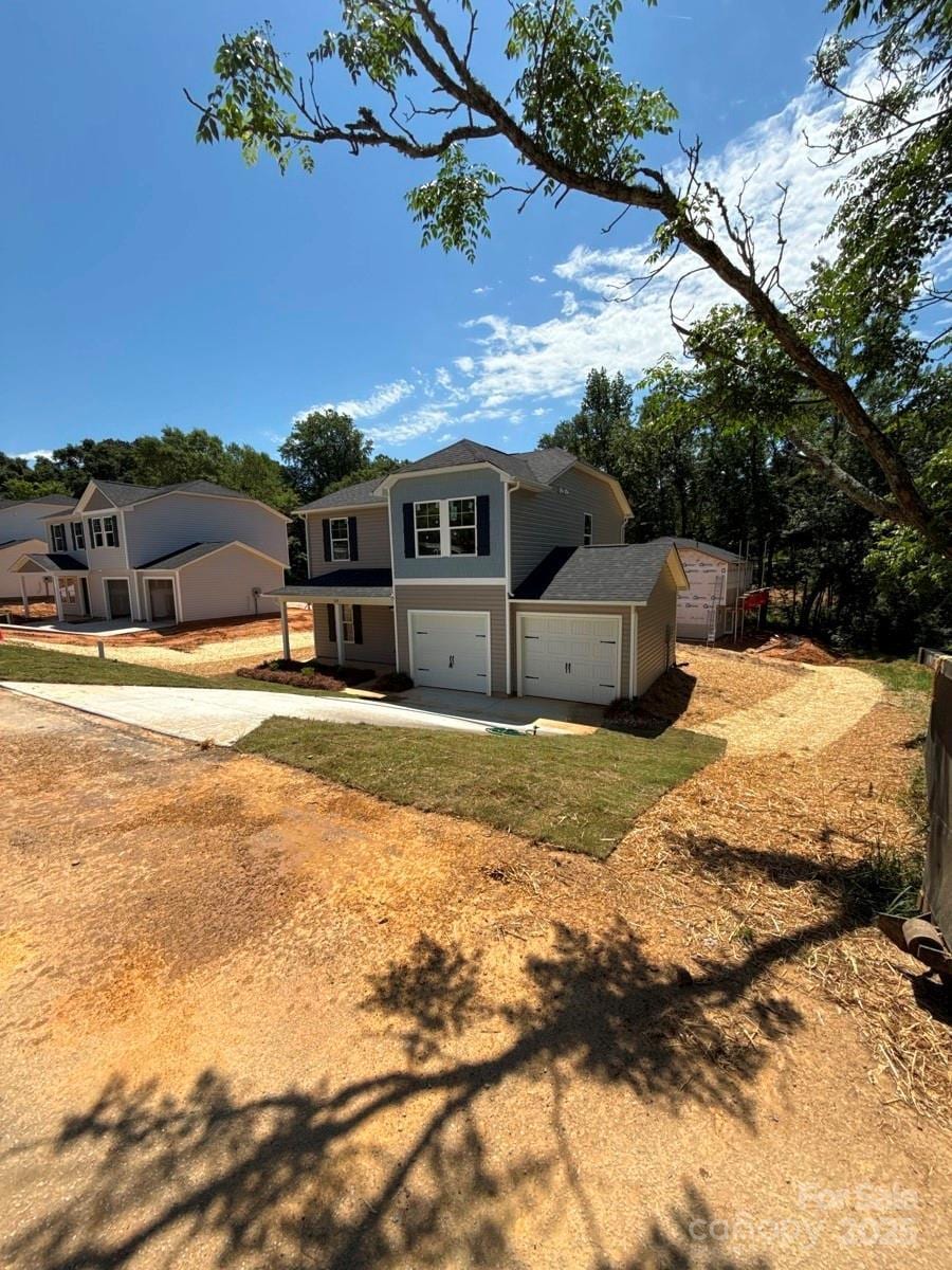 319 Conner St, Lancaster, SC 29720 - traditional-style house featuring a garage, driveway, and a shingled roof