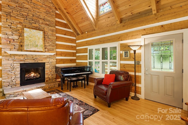 1980 Old Murray Rd, Mars Hill, NC 28754 - living area with wood finished floors, a stone fireplace, a wooden ceiling with exposed beams, wood walls, and high vaulted ceiling