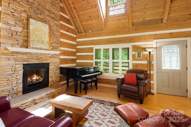 1980 Old Murray Rd, Mars Hill, NC 28754 - living area with a wood ceiling with exposed beams, wood finished floors, plenty of natural light, a stone fireplace, and wood walls