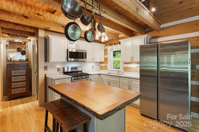 1980 Old Murray Rd, Mars Hill, NC 28754 - kitchen featuring stainless steel appliances, butcher block countertops, light wood-type flooring, tasteful backsplash, and white cabinetry