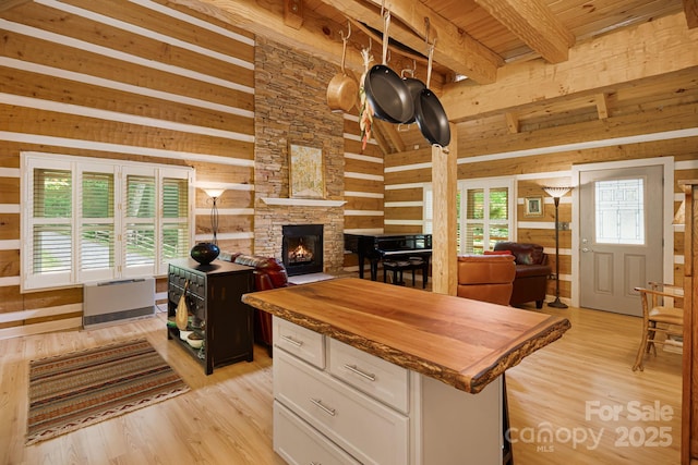 1980 Old Murray Rd, Mars Hill, NC 28754 - kitchen featuring wooden counters, wood walls, light wood finished floors, white cabinets, and a fireplace