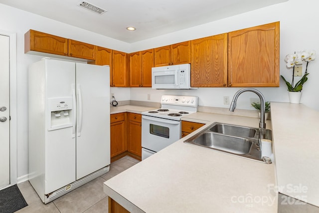 409 Lexie Ln, Rock Hill, SC 29732 - kitchen featuring white appliances, light countertops, brown cabinetry, light tile patterned floors, and recessed lighting
