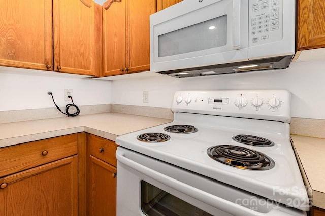 409 Lexie Ln, Rock Hill, SC 29732 - kitchen featuring white appliances, light countertops, and brown cabinets