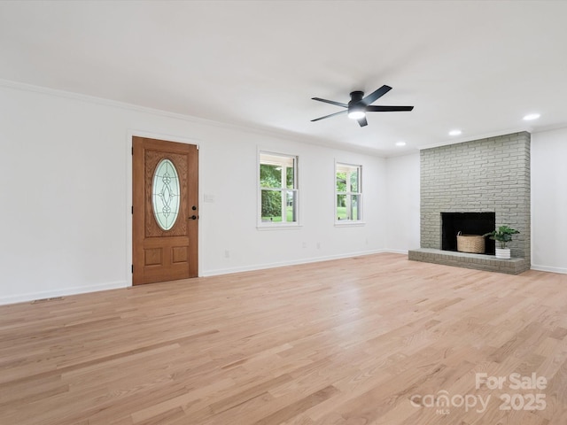 10728 Forest Dr, Matthews, NC 28105 - unfurnished living room with light wood finished floors, ceiling fan, ornamental molding, a brick fireplace, and recessed lighting