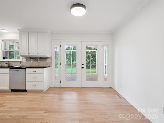 10728 Forest Dr, Matthews, NC 28105 - kitchen with dishwasher, light wood finished floors, backsplash, french doors, and dark countertops