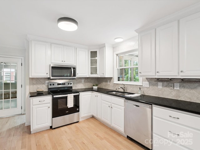 10728 Forest Dr, Matthews, NC 28105 - kitchen featuring appliances with stainless steel finishes, decorative backsplash, white cabinetry, and dark countertops