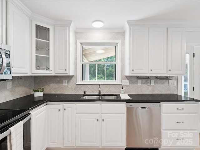 10728 Forest Dr, Matthews, NC 28105 - kitchen featuring stainless steel appliances, white cabinets, backsplash, and ornamental molding