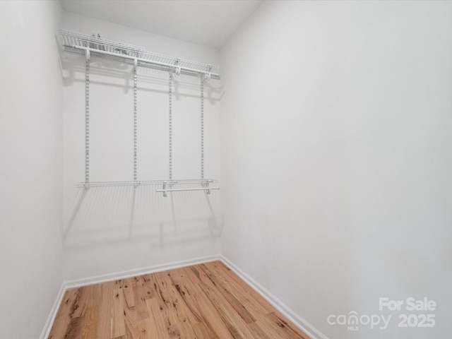 10728 Forest Dr, Matthews, NC 28105 - walk in closet featuring light wood-type flooring