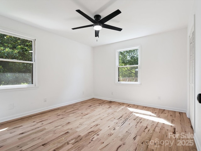 10728 Forest Dr, Matthews, NC 28105 - unfurnished bedroom featuring wood finished floors, multiple windows, a closet, and a ceiling fan