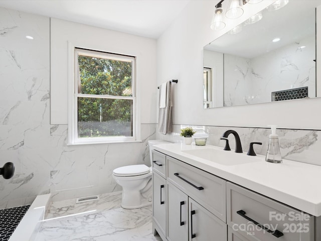 10728 Forest Dr, Matthews, NC 28105 - full bathroom with vanity, marble tiled floors, a marble finish shower, and tile walls