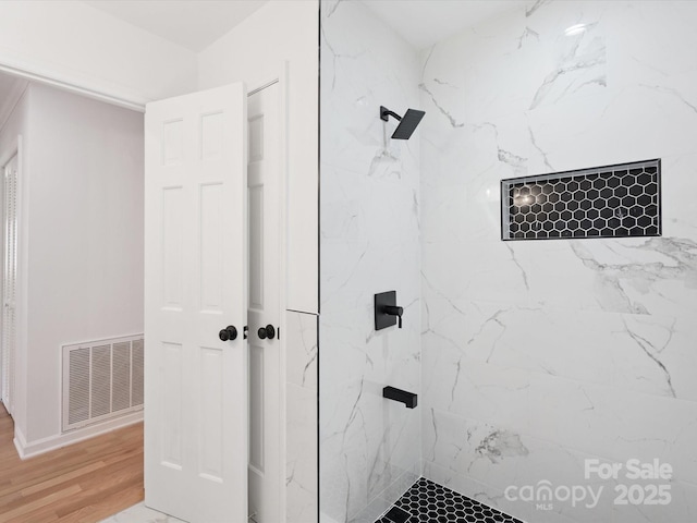 10728 Forest Dr, Matthews, NC 28105 - full bathroom with a marble finish shower and wood finished floors