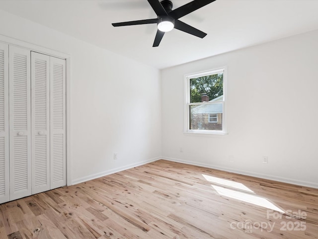 10728 Forest Dr, Matthews, NC 28105 - unfurnished bedroom with wood finished floors, a ceiling fan, and a closet