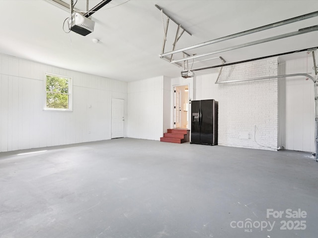 10728 Forest Dr, Matthews, NC 28105 - garage featuring black fridge with ice dispenser and a garage door opener