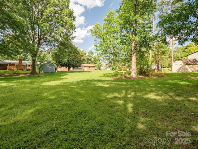 10728 Forest Dr, Matthews, NC 28105 - view of grassy yard with a storage unit
