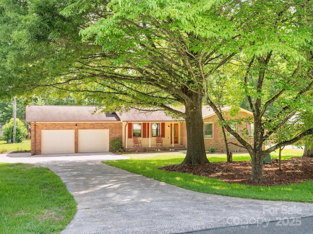 10728 Forest Dr, Matthews, NC 28105 - view of front facade featuring driveway, an attached garage, brick siding, and a front yard