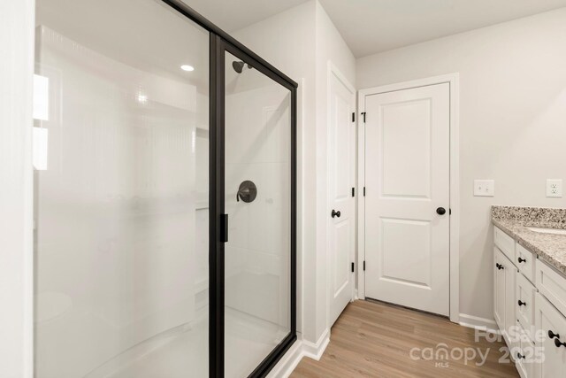 1059 Russell Dr, Winston Salem, NC 27127 - full bathroom featuring vanity, wood finished floors, and a stall shower
