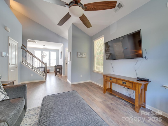 120 Prairie View Ct, Belmont, NC 28012 - living room with wood finished floors, stairway, vaulted ceiling, a ceiling fan, and a chandelier
