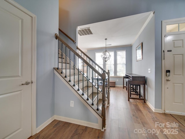 120 Prairie View Ct, Belmont, NC 28012 - entryway featuring a chandelier, stairway, wood finished floors, and ornamental molding