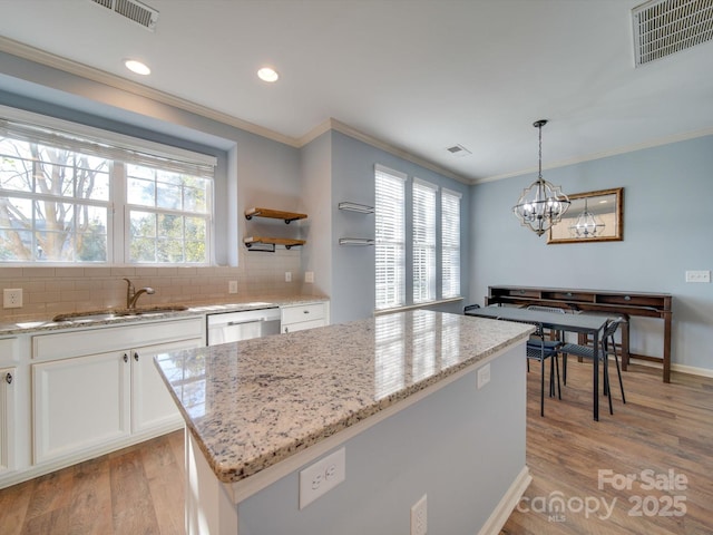 120 Prairie View Ct, Belmont, NC 28012 - kitchen featuring stainless steel dishwasher, ornamental molding, a chandelier, white cabinetry, and light wood-style floors