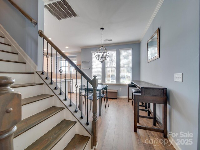 120 Prairie View Ct, Belmont, NC 28012 - stairs featuring crown molding, a chandelier, and wood finished floors