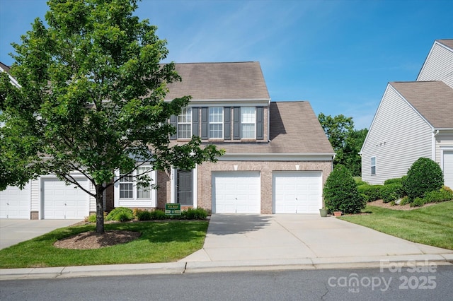 1498 Burrell Ave NW, Concord, NC 28027 - view of front of home featuring brick siding, concrete driveway, a garage, a front yard, and roof with shingles