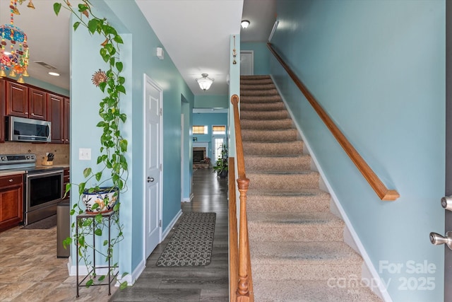 1498 Burrell Ave NW, Concord, NC 28027 - staircase featuring baseboards and wood finished floors