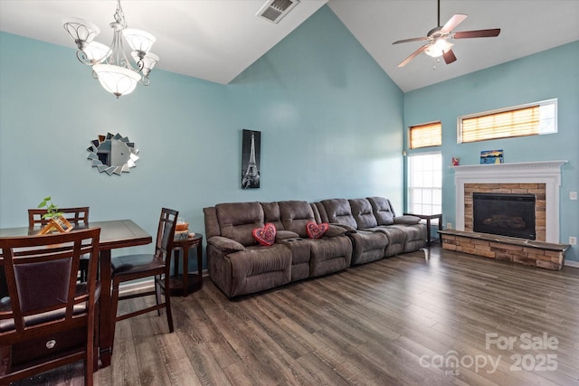 1498 Burrell Ave NW, Concord, NC 28027 - living room featuring high vaulted ceiling, a ceiling fan, wood finished floors, a chandelier, and a fireplace