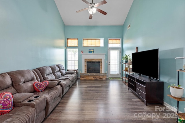 1498 Burrell Ave NW, Concord, NC 28027 - living room with high vaulted ceiling, a ceiling fan, wood finished floors, and a stone fireplace