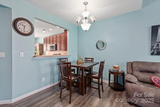 1498 Burrell Ave NW, Concord, NC 28027 - dining space with wood finished floors, a chandelier, and recessed lighting