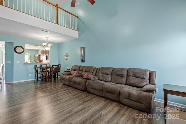 1498 Burrell Ave NW, Concord, NC 28027 - living room with a ceiling fan, wood finished floors, a chandelier, and a high ceiling