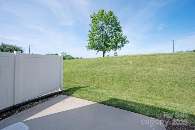 1498 Burrell Ave NW, Concord, NC 28027 - view of grassy yard featuring a rural view and a patio area