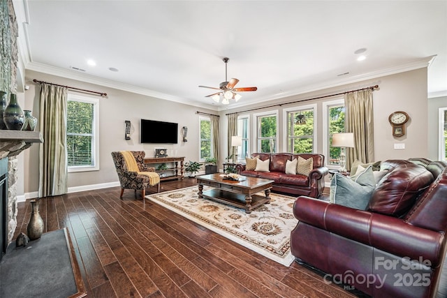 16547 Bastille Dr, Charlotte, NC 28278 - living room featuring healthy amount of natural light, a ceiling fan, a glass covered fireplace, dark wood-type flooring, and ornamental molding