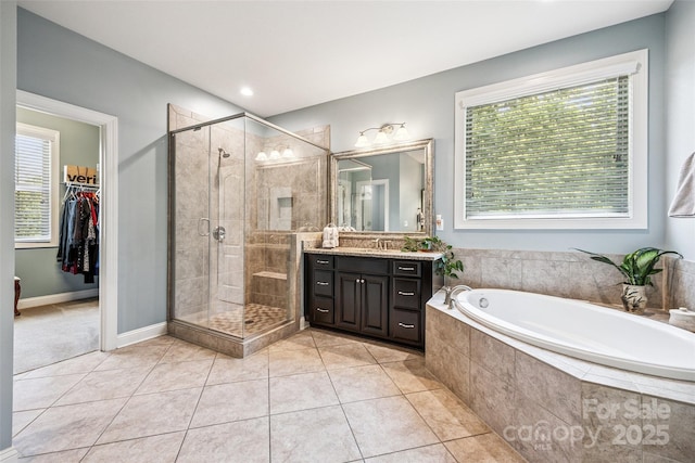 16547 Bastille Dr, Charlotte, NC 28278 - bathroom featuring vanity, a garden tub, a shower stall, tile patterned flooring, and a spacious closet