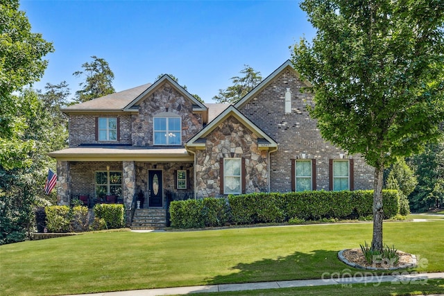 16547 Bastille Dr, Charlotte, NC 28278 - view of front of home with a front lawn, stone siding, and a porch