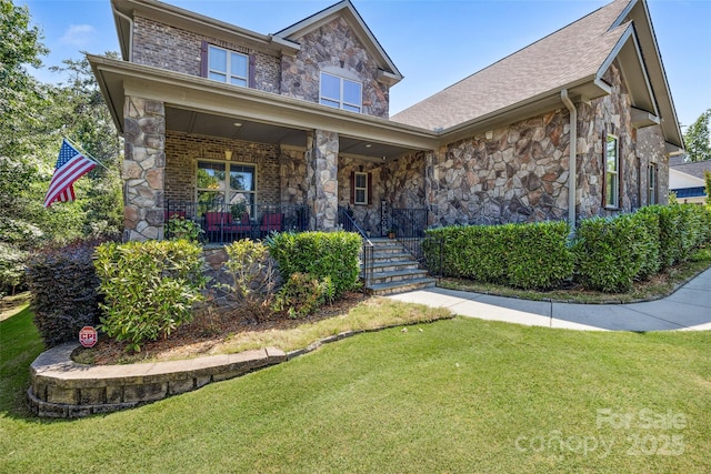 16547 Bastille Dr, Charlotte, NC 28278 - craftsman-style home with stone siding, a front yard, and covered porch