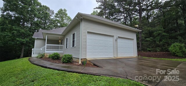221 Flat Branch Trl, Mill Spring, NC 28756 - view of side of home featuring covered porch, concrete driveway, and an attached garage