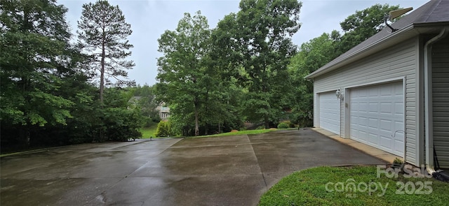 221 Flat Branch Trl, Mill Spring, NC 28756 - garage featuring view of scattered trees and driveway