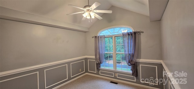 221 Flat Branch Trl, Mill Spring, NC 28756 - spare room featuring ceiling fan, wainscoting, vaulted ceiling, a decorative wall, and carpet