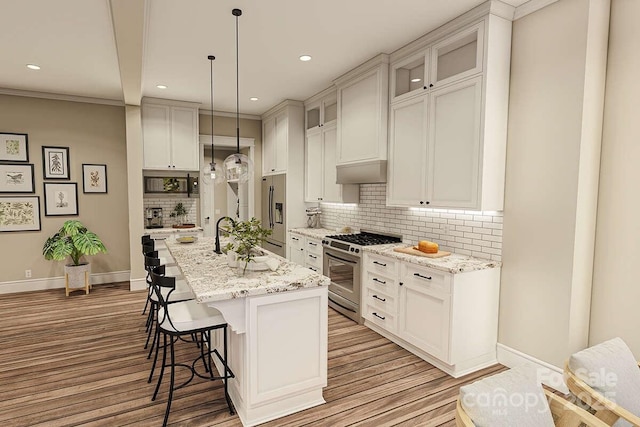 2106 Piper Ridge Dr, Lenoir, NC 28645 - kitchen with stainless steel appliances, a kitchen breakfast bar, light wood finished floors, recessed lighting, and backsplash