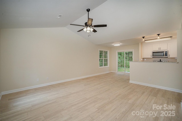 903 Brookdale St, Kannapolis, NC 28083 - unfurnished living room with ceiling fan, light wood-style flooring, and lofted ceiling