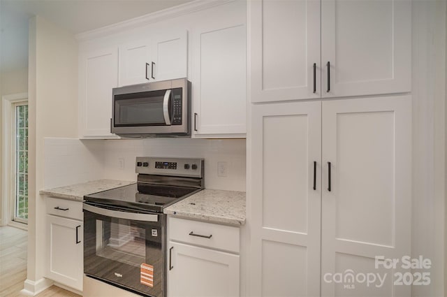 903 Brookdale St, Kannapolis, NC 28083 - kitchen with appliances with stainless steel finishes, decorative backsplash, white cabinetry, and light stone countertops